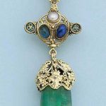 An Arts & Crafts emerald, ruby, sapphire and half-pearl brooch