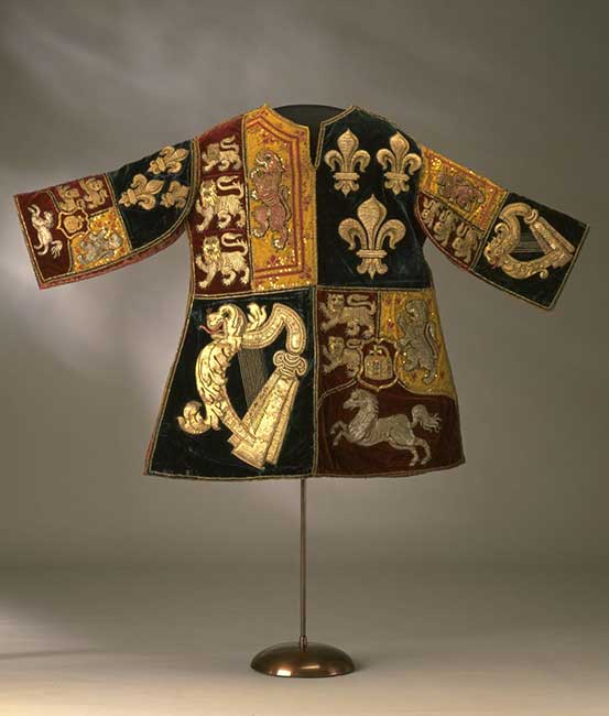 Red and blue silk velvet tabard, applied with cloth of gold and linen, embroidered with silver and silver-gilt thread, twist, bullion and purl in laid and couched work.