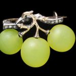 Brooch in the form of green glass grapes on a branch of silver backed in gold with rose-cut diamonds